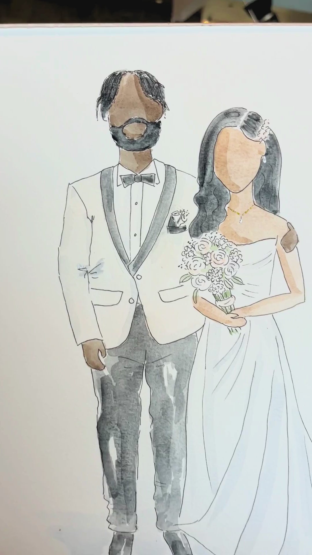 Load video: A newlywed couple reacts positively to Tiff Chou's live illustration of them and their guests.
